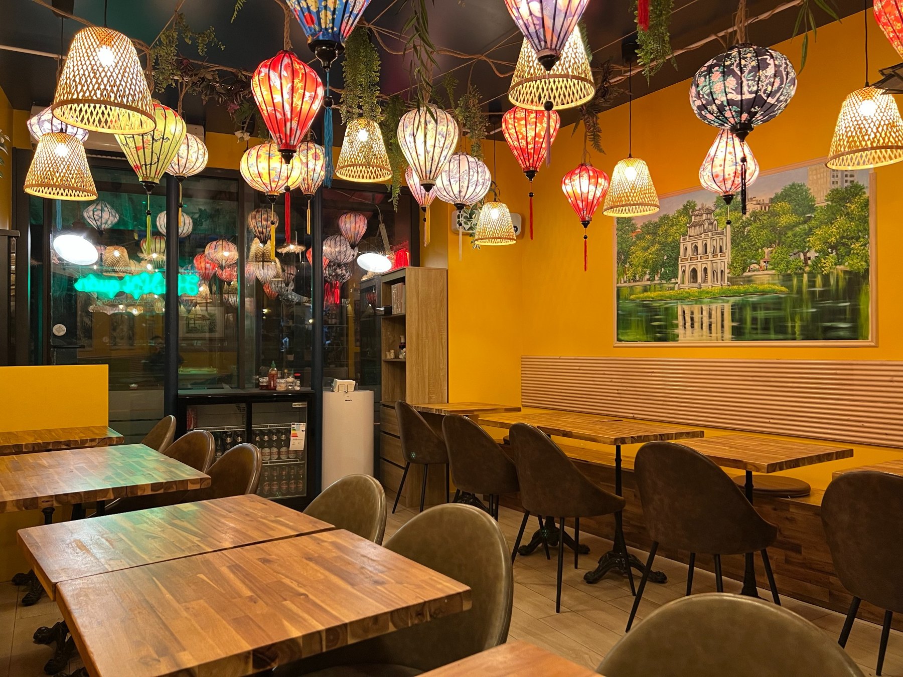 Warm dining room with wooden tables at Phở Hà Nội Quán